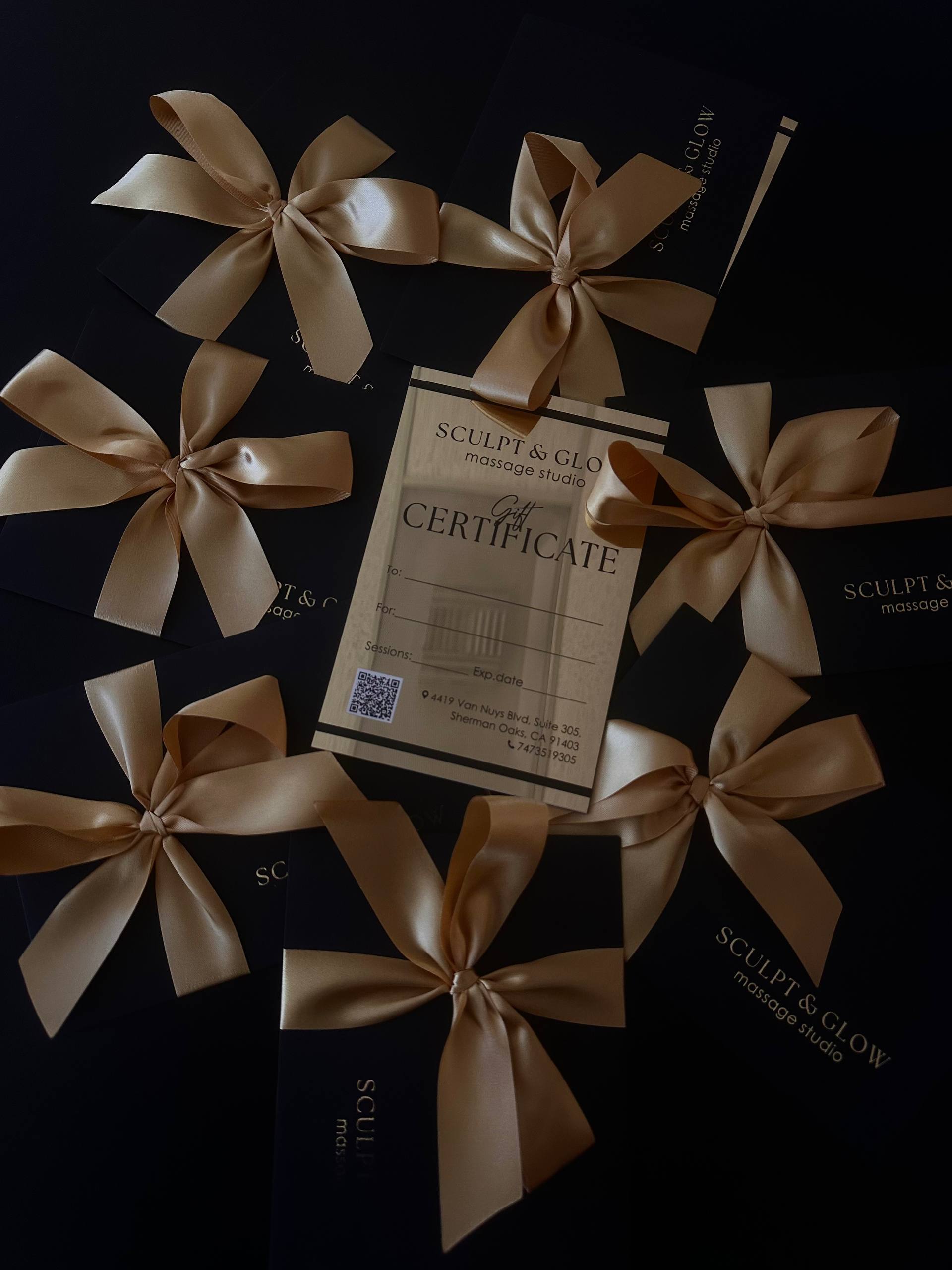 Sculpt & Glow by Kateryna gold gift certificates wrapped with champagne ribbon